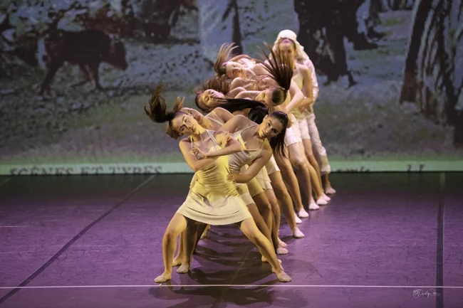 Groupe de danseuses modern jazz exécutant une chorégraphie élégante et synchronisée