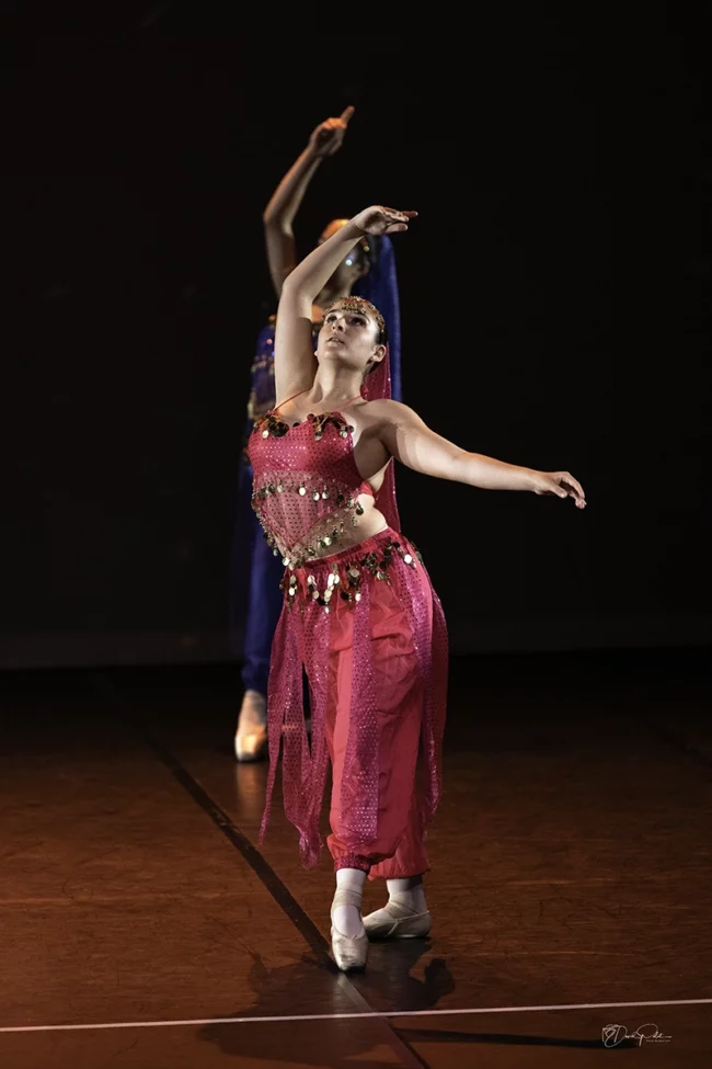 Danseuse orientale en solo, costume vibrant, exécutant une chorégraphie émotive